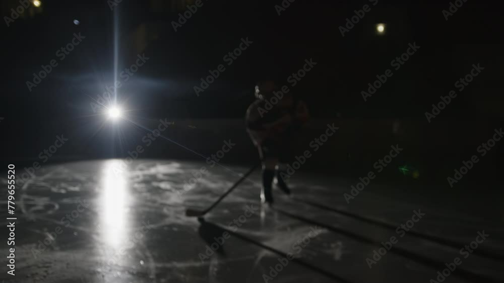 custom made wallpaper toronto digitalWarm-up before Ice hockey game. Players runs on skates and makes wrist shot Forward hits the goal in slow motion. Dark Ice arena with lights off. Focus on back light, silhouette. Handheld shaky shot