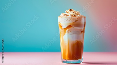 coffee with whipped cream and caramel syrup in glass on pastel colorful background, copy space