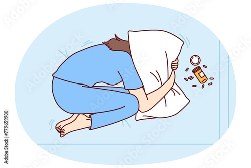 Depressed woman suffering from overdose of antidepressants covers head with pillow in need of qualified doctor help. Concept of overdose from drugs or prescription pills from psychotherapist