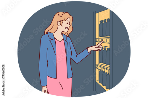 Woman stands near vending machine choosing snack or drink to buy and satisfy hunger and thirst. Young happy girl wishes to buy soda or sandwich in vending machine or automated store