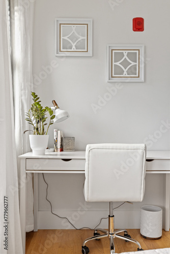 a white desk has been converted with chairs in front of it © Wirestock