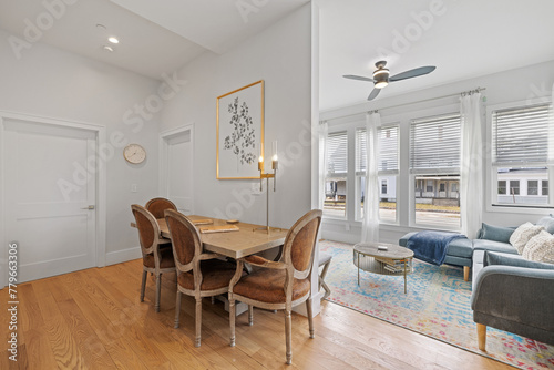 a dining table and several chairs in the room with wooden floors