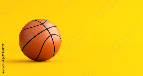 Basketball on yellow background with copy space.