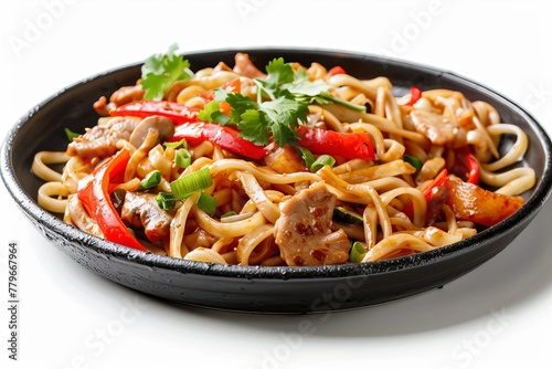 Asian street food pork and vegetable udon wok noodles in sweet and sour sauce on black plate with white background