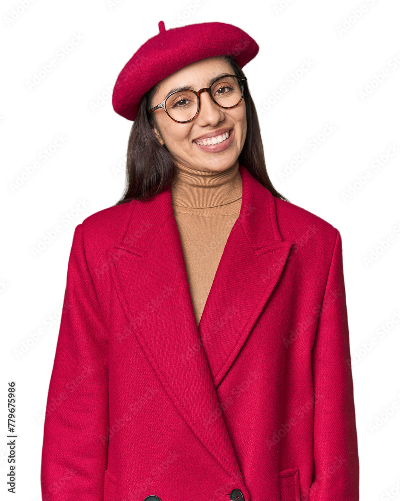 Fototapeta premium Stylish young Caucasian woman in red trench coat and beret on studio background happy, smiling and cheerful.