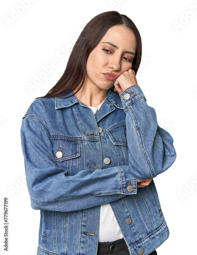 Modern young Caucasian woman portrait on studio background who feels sad and pensive, looking at copy space.