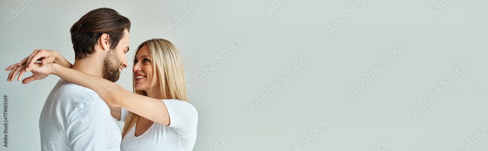 A man and a woman hold each other in an intimate moment, showcasing the romance between them, banner A man and a woman hold each other in an intimate moment, showcasing the romance between them, banner