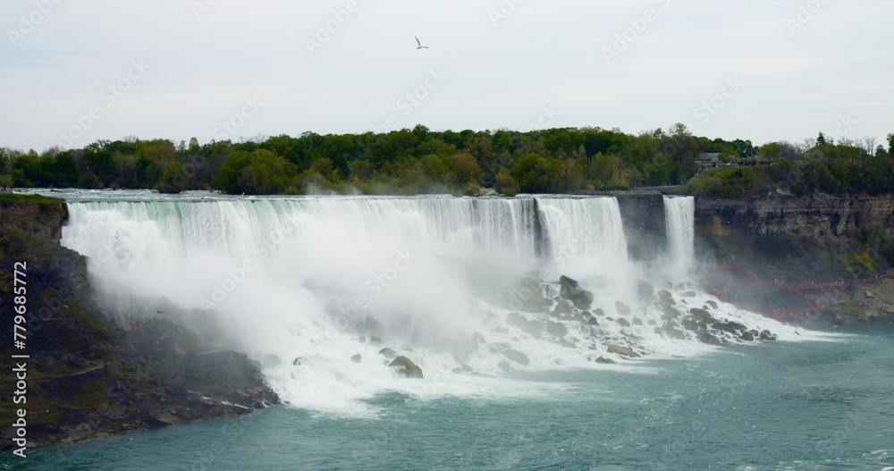 River pier near Niagara Falls. Formation of tourist cruises to waterfalls on Maid of Mist boats. Process of forming cruises near famous natural waterfalls of North America. Tourism industry concept River pier near Niagara Falls. Formation of tourist cruises to waterfalls on Maid of Mist boats. Process of forming cruises near famous natural waterfalls of North America. Tourism industry concept