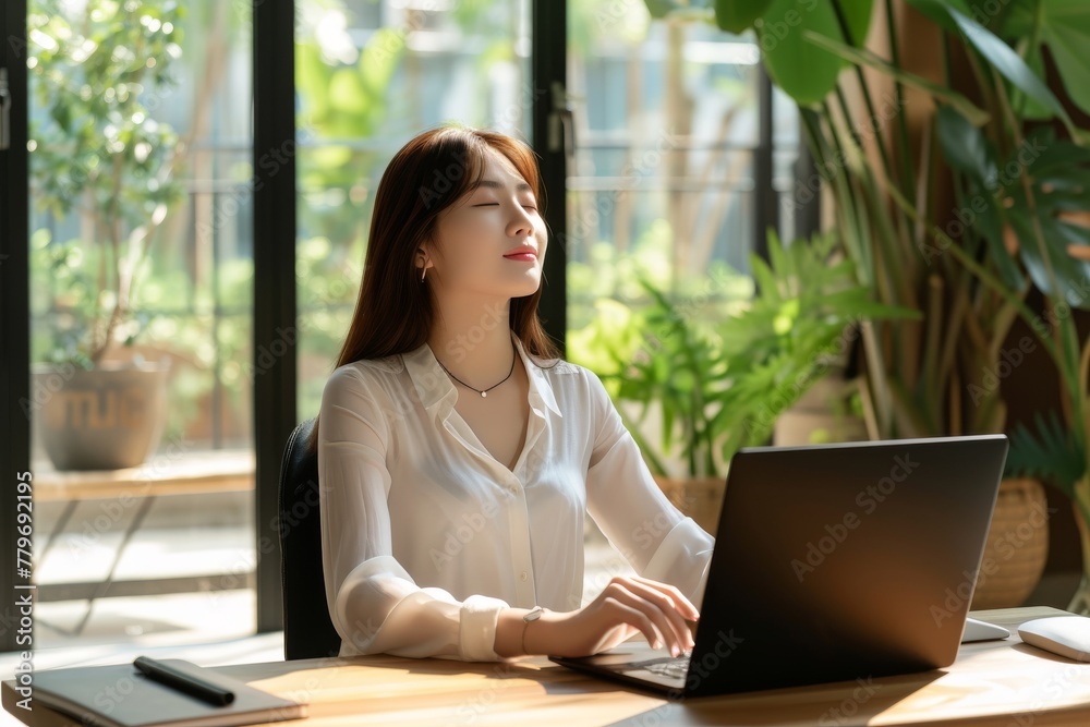 Serene Businesswoman Taking a Mindful Break at Her Workspace, Concept of Workplace Wellness. Serene Businesswoman Taking a Mindful Break at Her Workspace, Concept of Workplace Wellness.