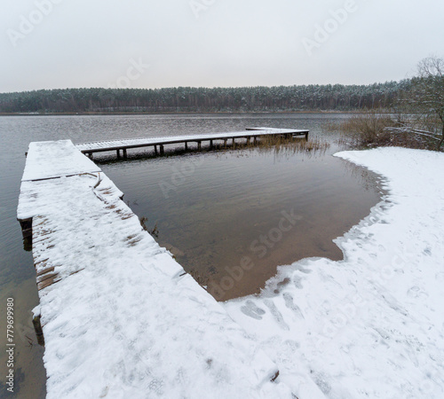Edge of Wooden Pier, Jetty, Dock at Peaceful Snowy Winter Lake, Silhouette © Mindaugas Dulinskas