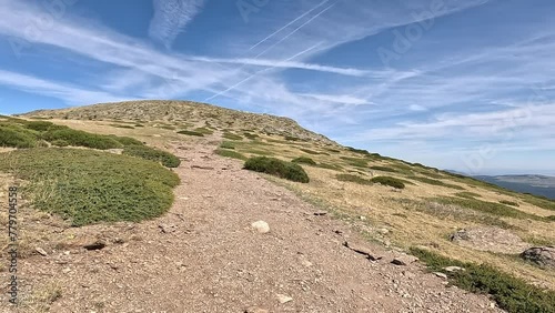 Trekking along a trail towards the Penalara peak, the highest mountain in Madrid, Spain. Point Of View (POV), subjective view photo