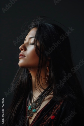 Portrait of a beautiful indigenous woman in traditional clothing on a dark background