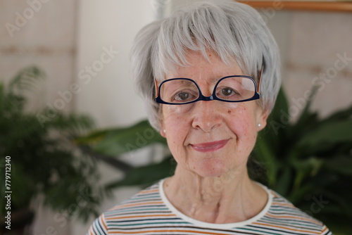 Senior woman wearing her eyeglasses upside down 