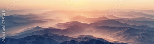 Aerial view of a majestic mountain range  undulating terrain under the soft glow of sunrise