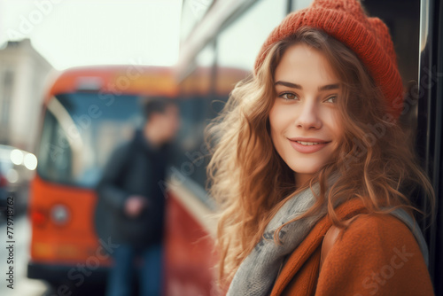 Smiling female college student in front of a bus