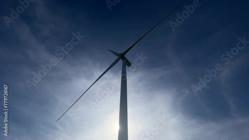 Wind turbines generating green energy. renewable electricity concept, sustainable energy, green power production. Wind mills on the blue sky background. Green energy packshot.