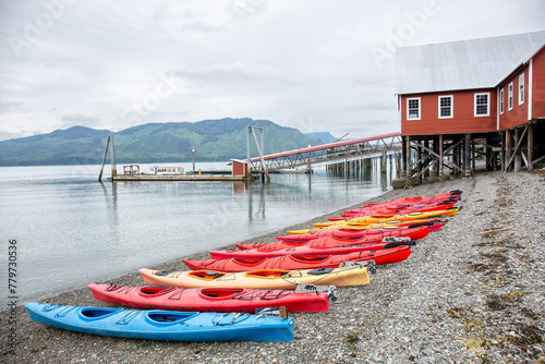 Kayak adventure in Alaska. Several sea kayaks are on the beach, ready to take an oudoor trip at sea photo
