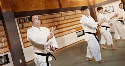 Aikido dojo, students and fight for martial arts, strike or together for combat at training, gym or class. Japanese people, group and sport for exercise, workout or fitness with zen, conflict or club