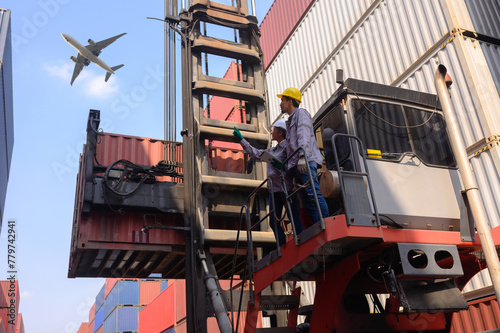 A group of men and women of professional container assemblers stand in a container shipping yard, looking at the preparation of containers. Logistics workers working at containers photo