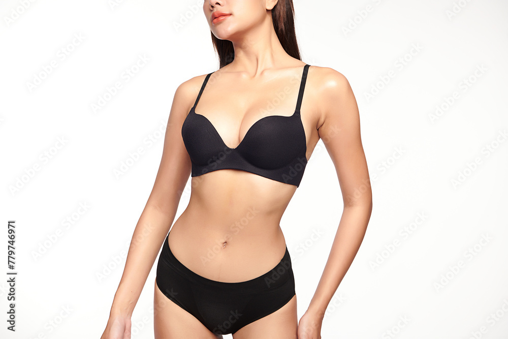 Fototapeta premium Confident beautiful young asian woman posing in black lingerie on white background, Perfect body,