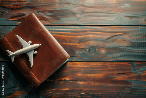 Toy airplane on top of a passport and flight booking ticket photo