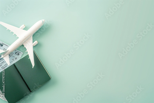 Toy airplane on top of a passport and flight booking ticket