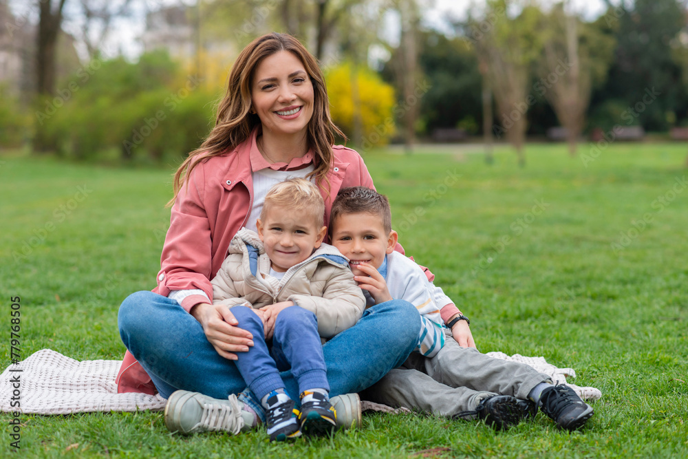  Portrait of mother and kids sitting in the park