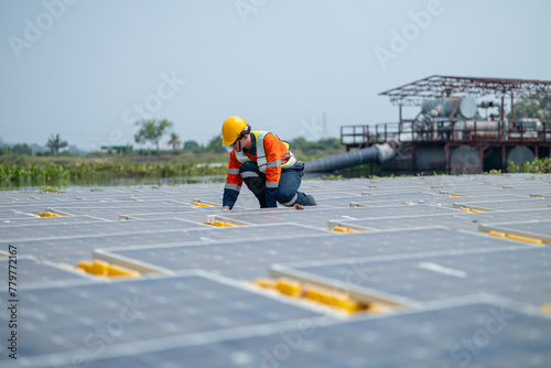 Engineer Inspecting Solar Panels at Power Plant