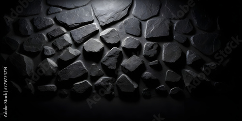 A stone wall stands starkly against a black background, showcasing its rugged texture and solidity