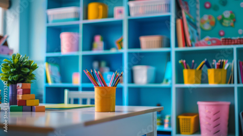 A colorful classroom with a yellow pencil holder on a white desk