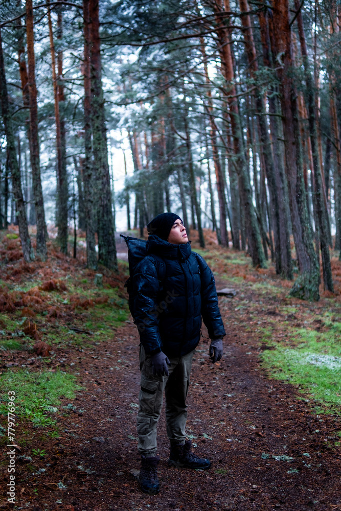 Man standing in snowy landscape, promoting rural tourism and environmental conservation. Man standing in snowy landscape, promoting rural tourism and environmental conservation.