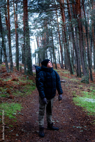 Man standing in snowy landscape, promoting rural tourism and environmental conservation.