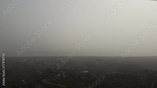 A ghostly calima haze blankets the sky over Marbella, casting a veil over the landscape and capturing a mystic, soft-focus view of Andalucia, Spain photo