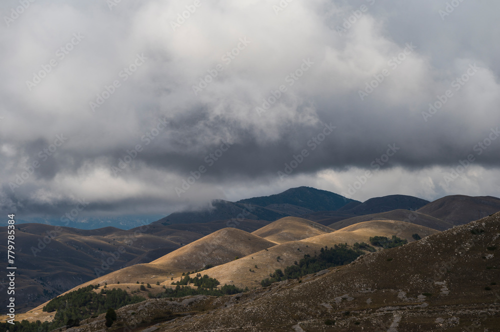 mountain landscape inside the National Parl of Gran Sasso and Monti della Laga during an autumnal and cloudy morning, L'Aquila, Italy mountain landscape inside the National Parl of Gran Sasso and Monti della Laga during an autumnal and cloudy morning, L'Aquila, Italy