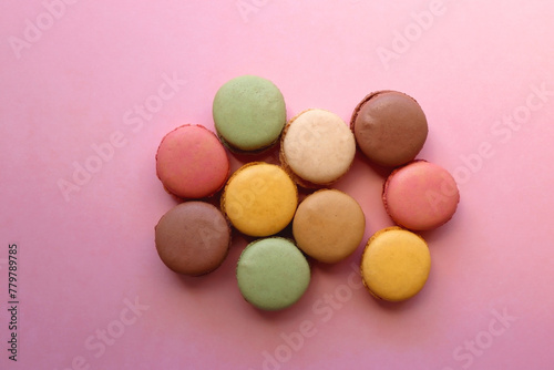 Colorful macarons on pink background. Top view.