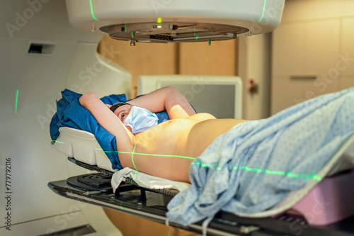 Cancer treatment in a modern medical private clinic or hospital with a linear accelerator. woman lay is undergoing radiation therapy for cancer