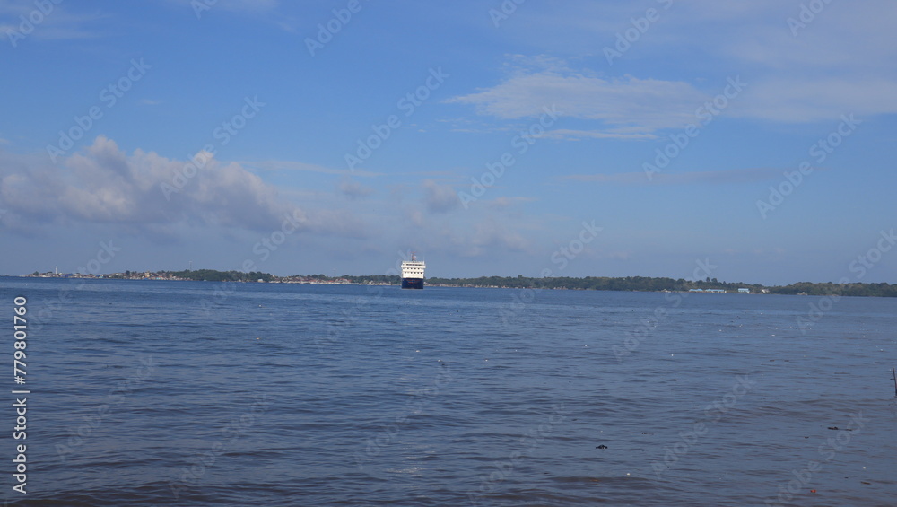 View of the sea from the beach, ships and islands visible from afar. View of the sea from the beach, ships and islands visible from afar.