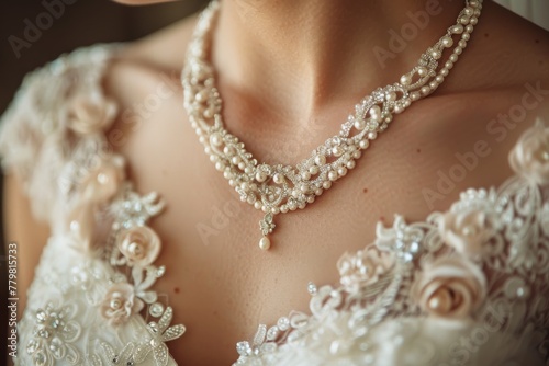 An exquisite close-up view of a bride's pearl necklace set against an intricately designed gown photo