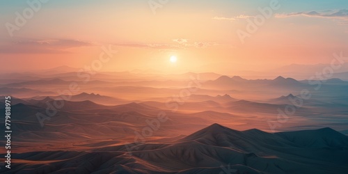 A beautiful sunset over a mountain range with a small sun in the sky. The sky is a mix of orange and pink colors