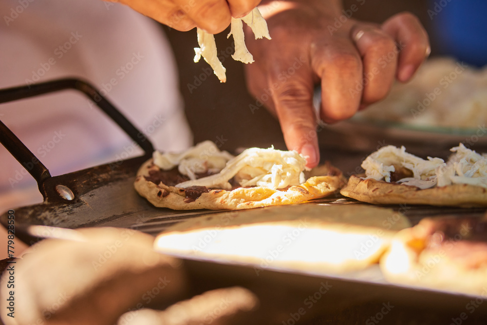 Mujer latina preparando sopes de quesillo con frijol. comida oaxaqueña - obrazy, fototapety, plakaty 