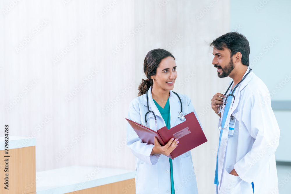 male and female doctors in white medical uniforms discuss patient anamnesis together. team brainstorming make decision concept. male and female doctors in white medical uniforms discuss patient anamnesis together. team brainstorming make decision concept.