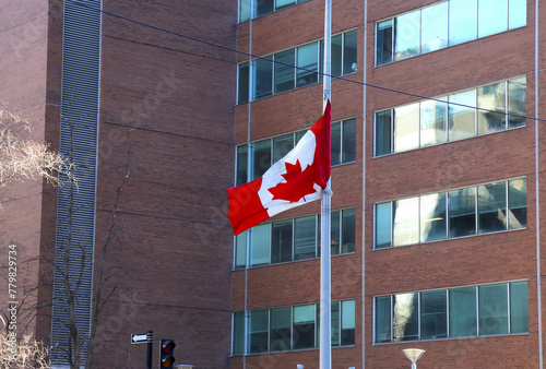 Beautiful Canada flag is waving front of business building in Downtown of Montreal