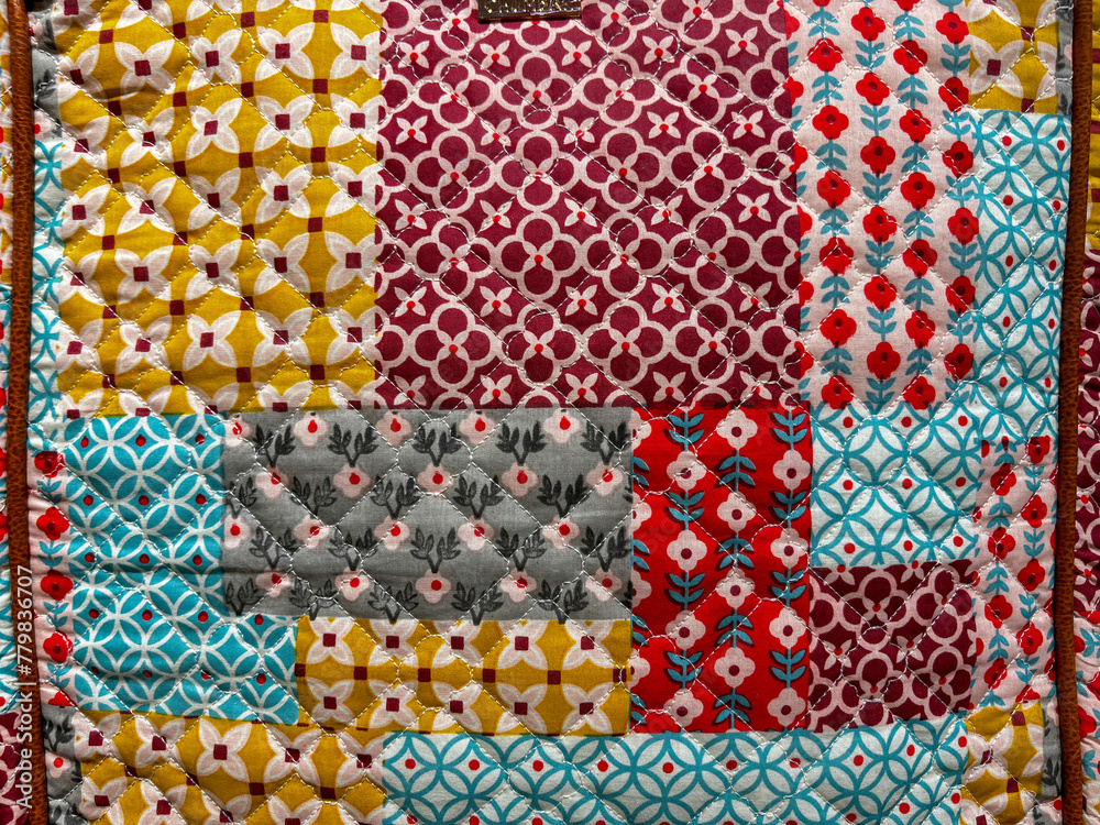 A colorful quilt with a variety of patterns and colors