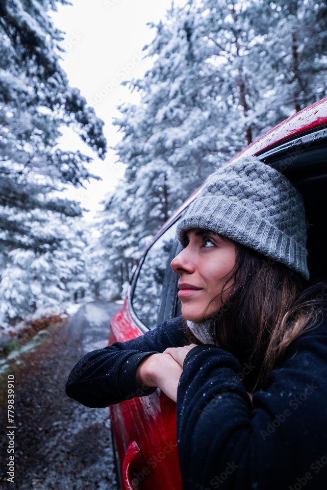 Woman's contemplative gaze reflects respect for snowy nature in Sierra de Guadarrama.
