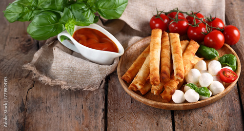 traditional cigar borek with sauce and salad photo