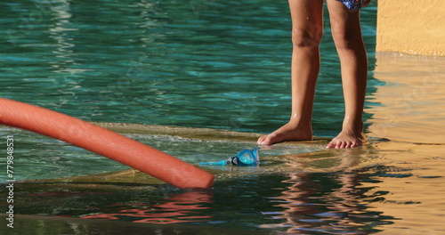 Small boy going underwater at the swimming pool