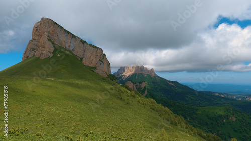 A spectacular view of the North Caucasus mountain range in southwestern Russia, showing the natural beauty of the rocky peaks under rain clouds. photo