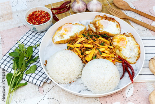 Traditional Thai street food, Jumbo Stir Fried Pork And Bamboo Shoot With Basil with 3 Egg