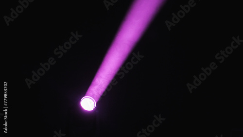 Intense purple light beams from the spotlight, creating a dramatic and vibrant atmosphere ideal for concerts, theater performances or festivals.