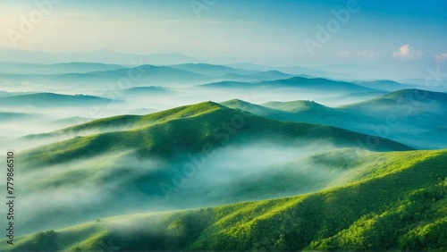 Green Hills Covered in Fog Against a Blue Sky, Reflecting the Serene Beauty of Nature and Environmental Balance © Денис Богдан
